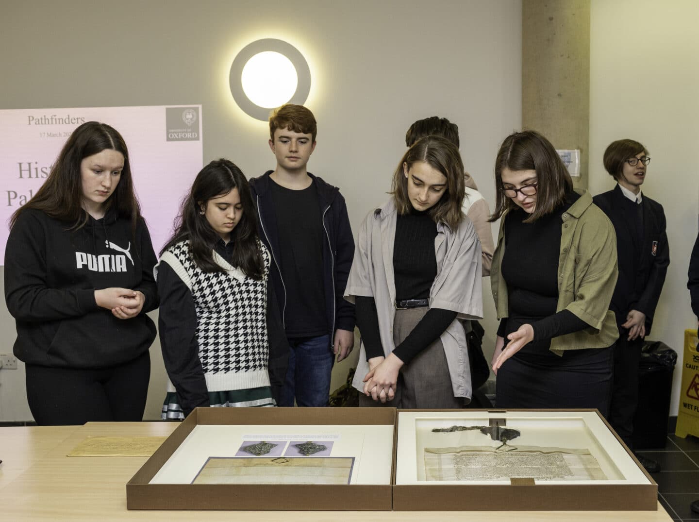 Secondary school students looking at archival materials
