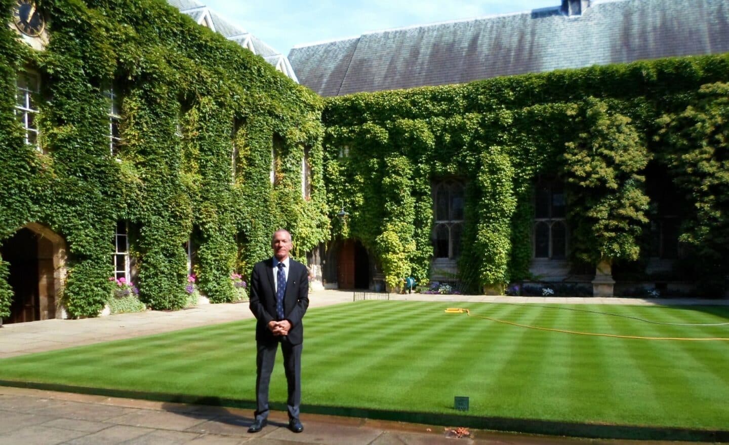 Bob Weatherhead standing in the Front Quad on his first day as a porter