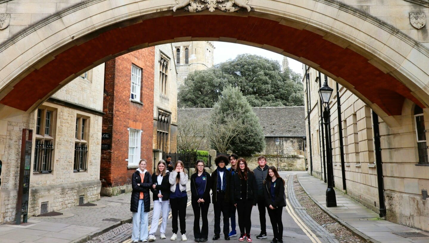 A group of young students under the Hertford College Bridge