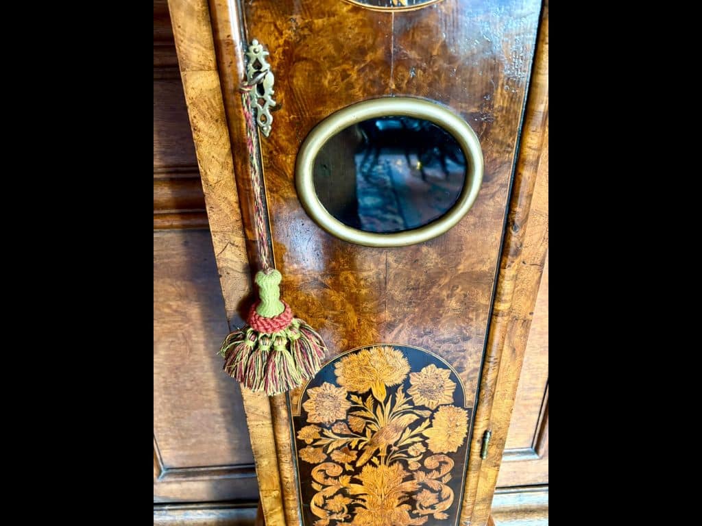 Photo of ornate wood carved front case of Daniel Quare clock in Lower SCR
