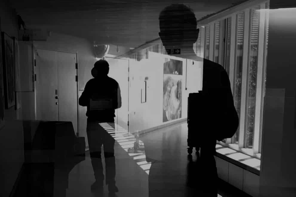 A man wearing a mask during the pandemic, in black and white