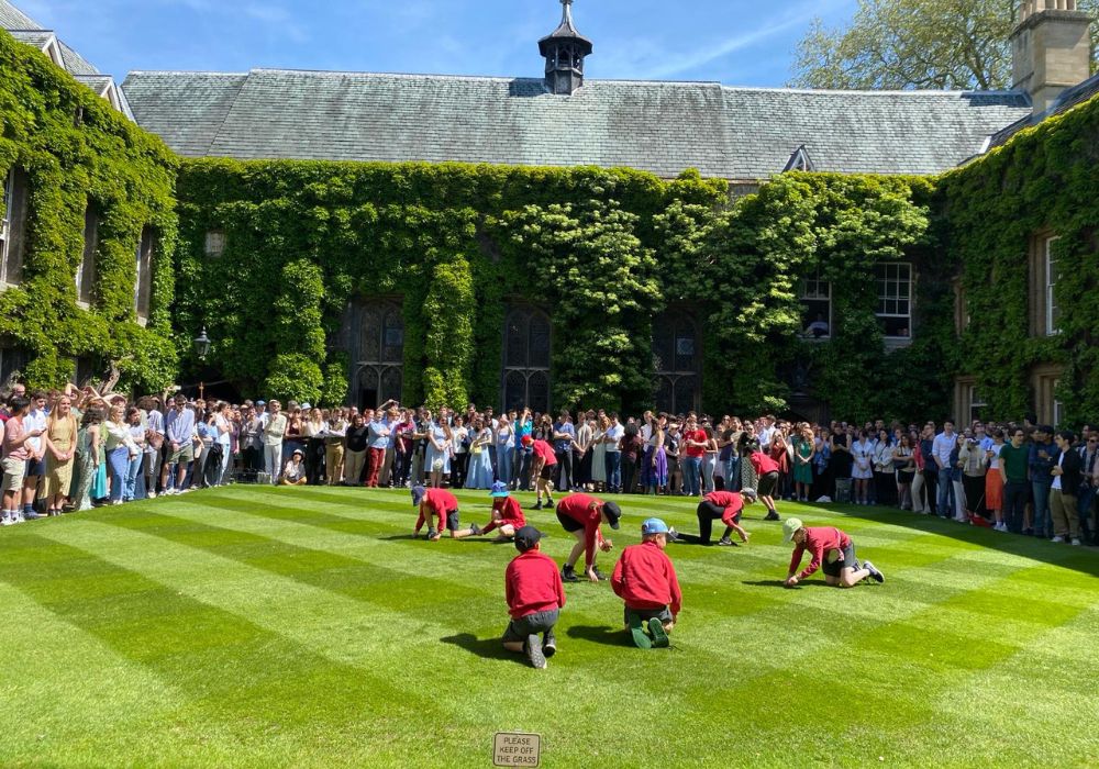 Photo of primary school children collecting pennies in Front Quad on Ascension Day
