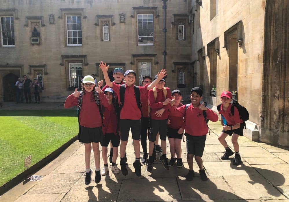 Primary school children posed in Front Quad on Ascension Day wearing school uniform