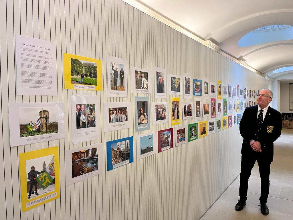 Bob Weatherhead standing in front of wall of his photos