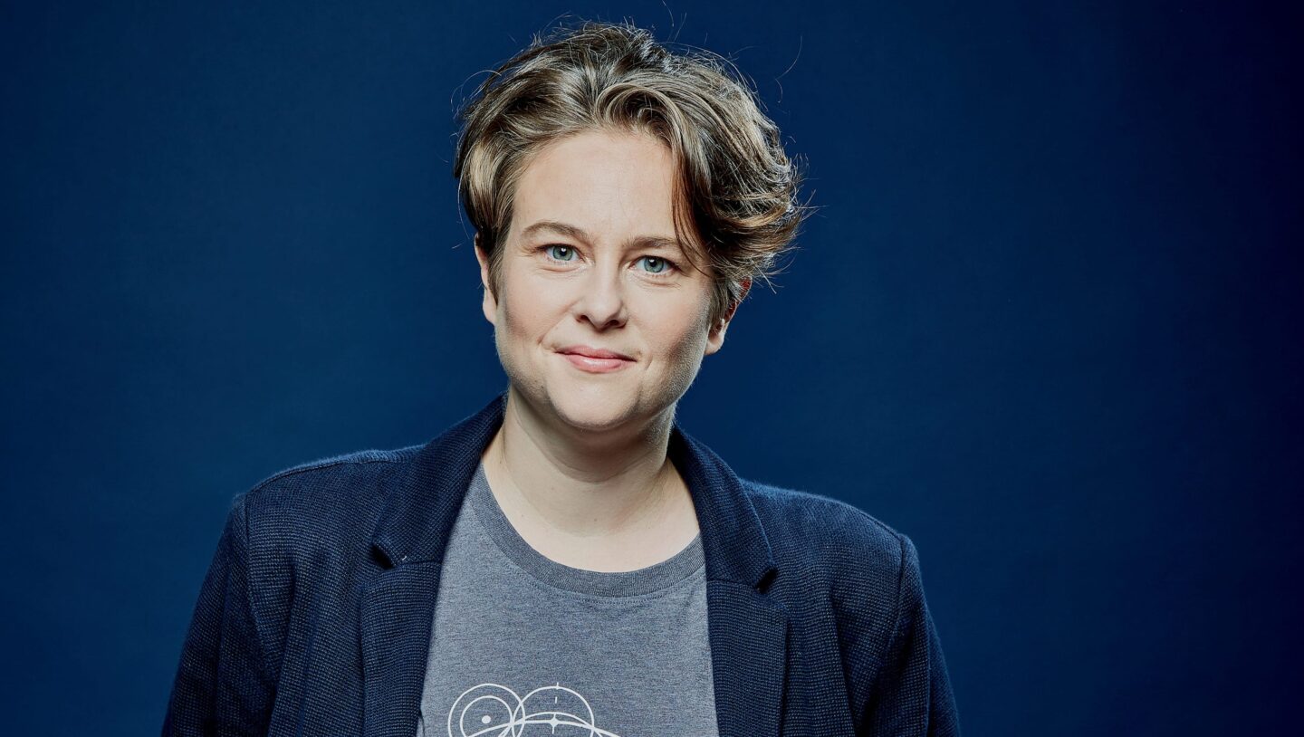 Photo of Emily Howard against a blue background