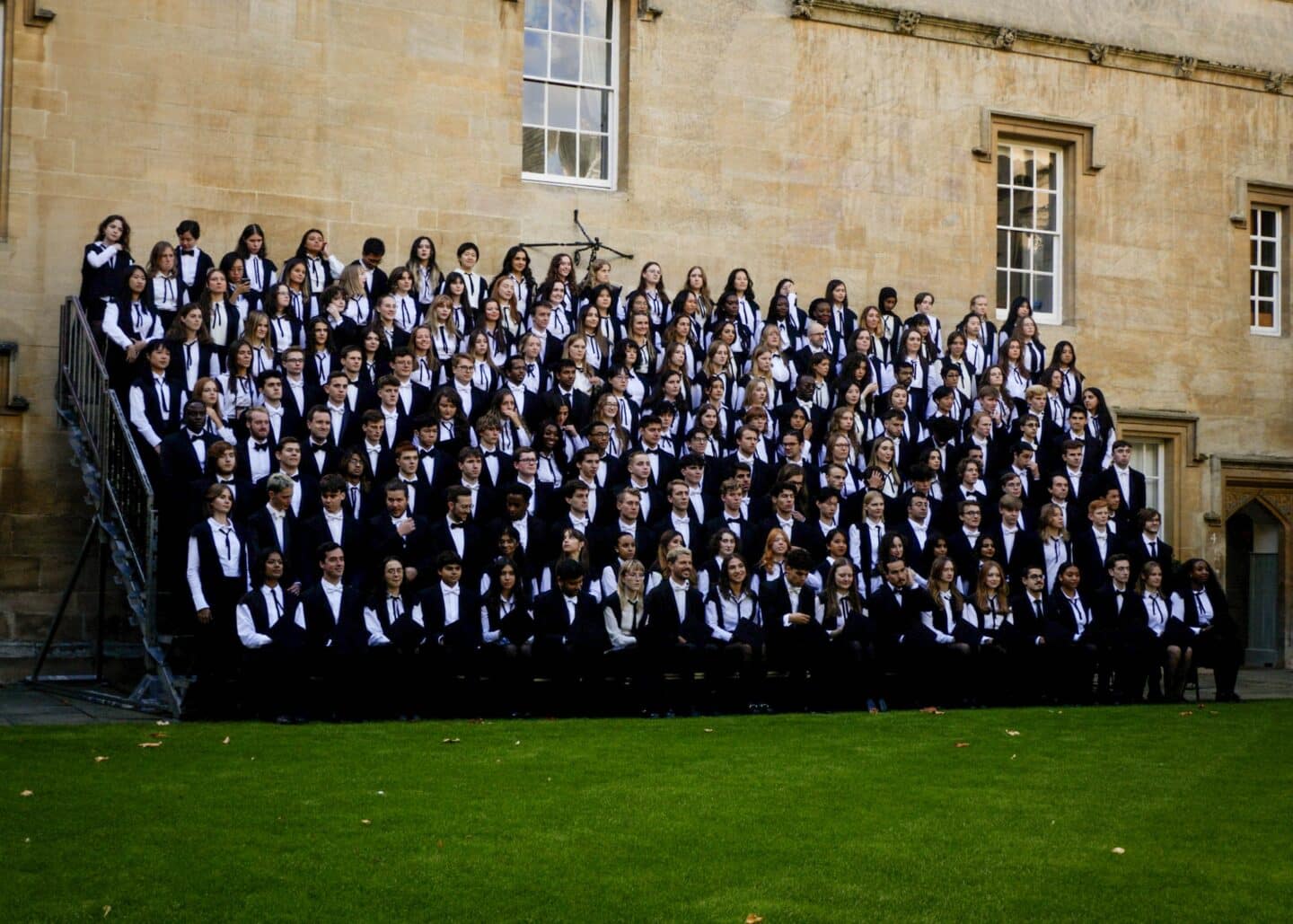 Matriculation photograph of a large group of students in subfusc lined up in rows