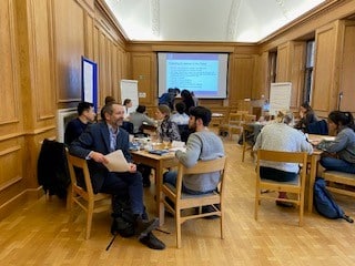 Students sitting in groups in the Oakeshott Room