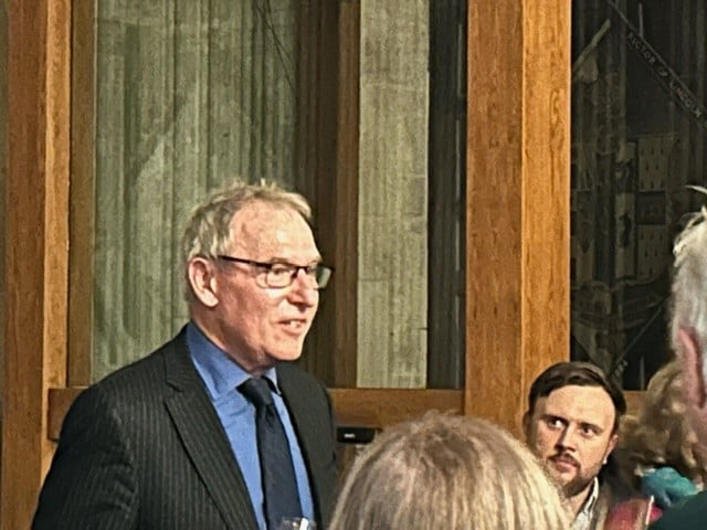Photo of Henry Woudhuysen standing with others in the Lincoln Library