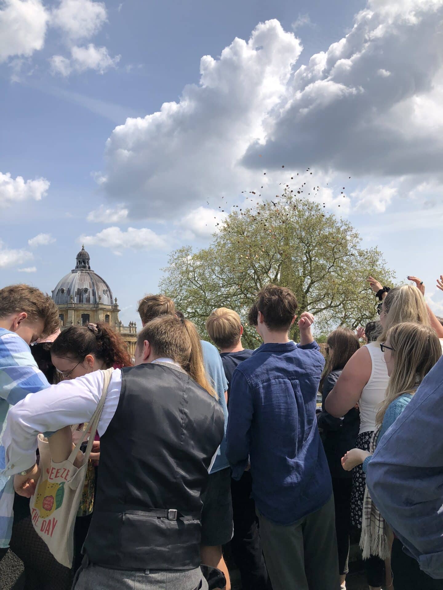 Ascension Day 2023. JCR Committee members throwing pennies from the Tower
