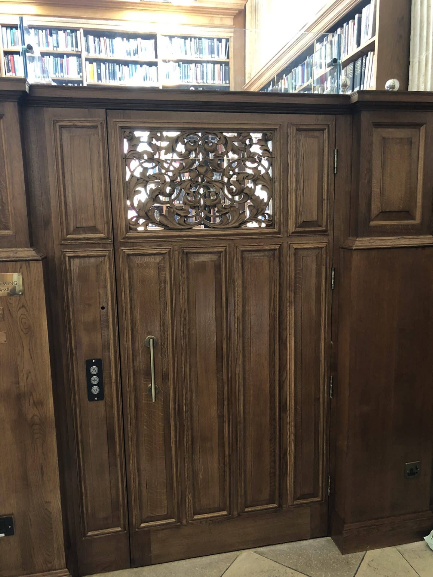 Photo of ornate wooden door to Library lift