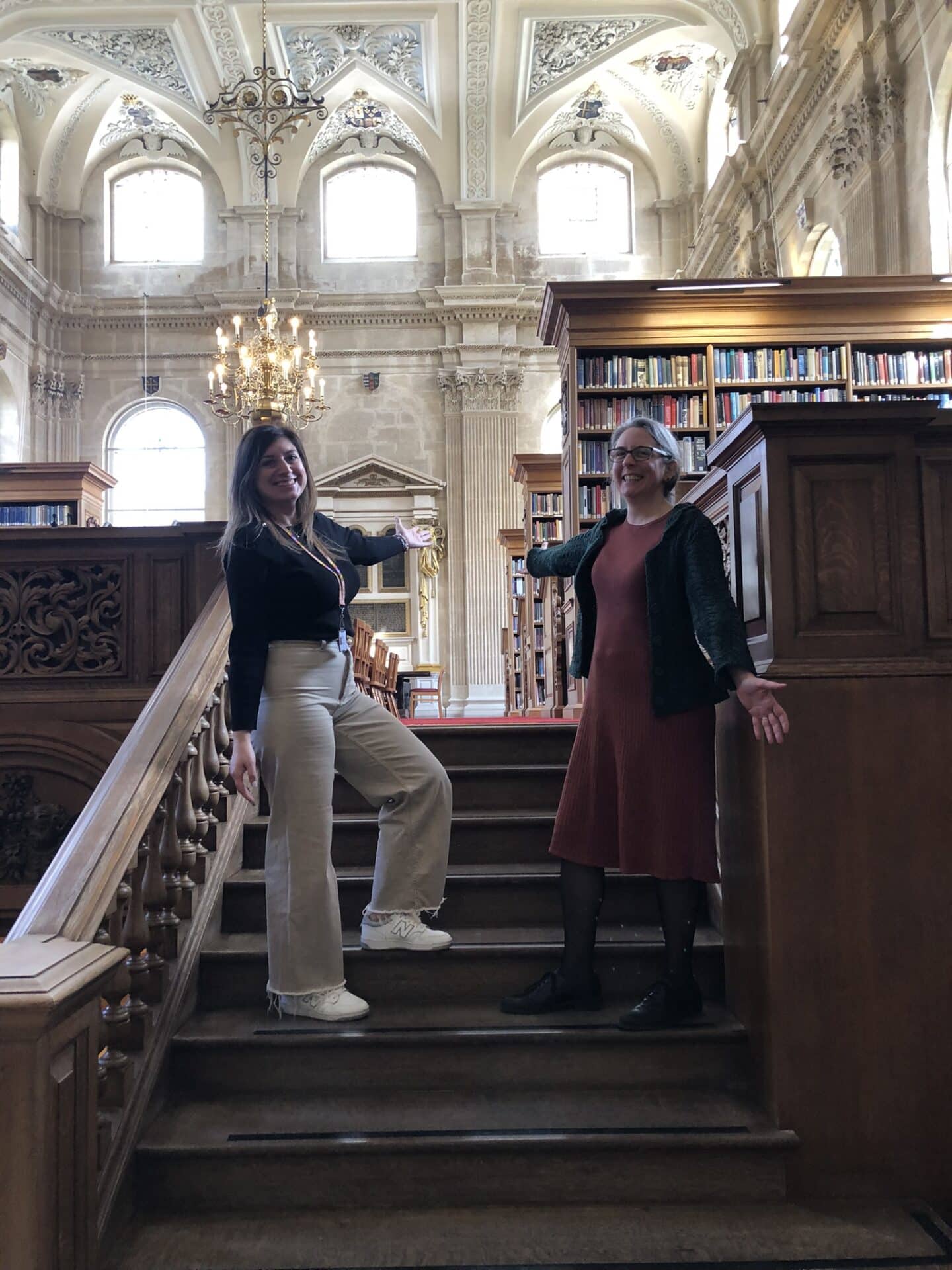 Lincoln librarians Lucy Matheson and Marina Sotiriou smiling on the Library stairs