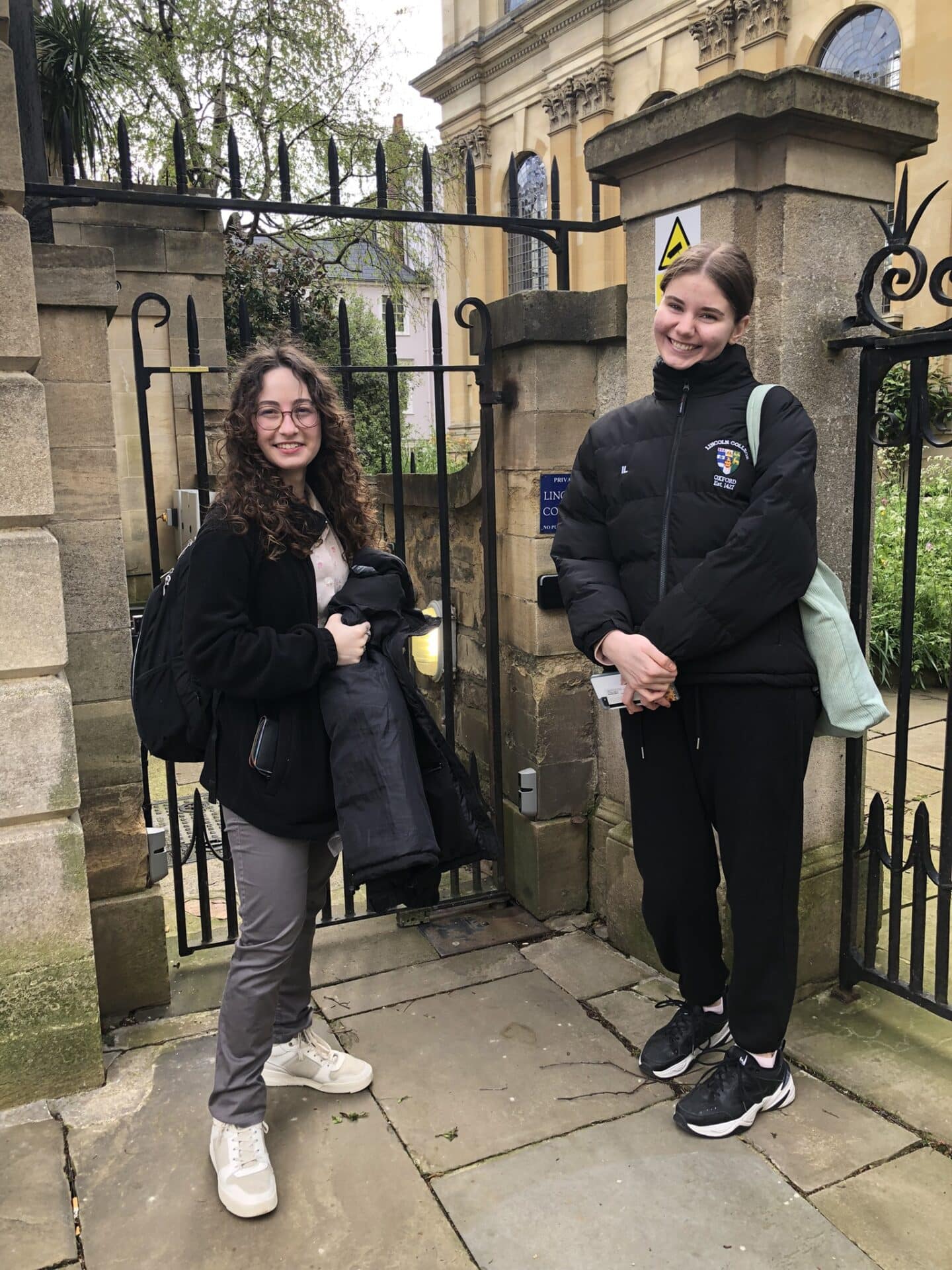 Two students outside the gate to the Lincoln College Library