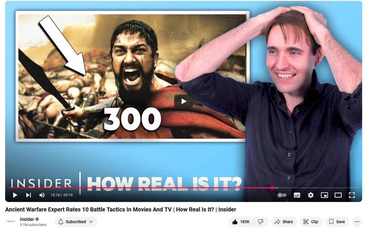 YouTube screenshot from Insider’s ‘How Real Is It?’ series, featuring an Roel Konijnendijk reacting to battle tactics from movies. The screen shows a still from the film ‘300’ with a Spartan warrior shouting, alongside the Roel holding his head in amused disbelief.