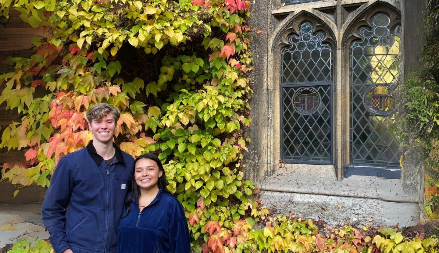 Photo of 2 Jepson Scholars standing in front of Boston Ivy with window to the right
