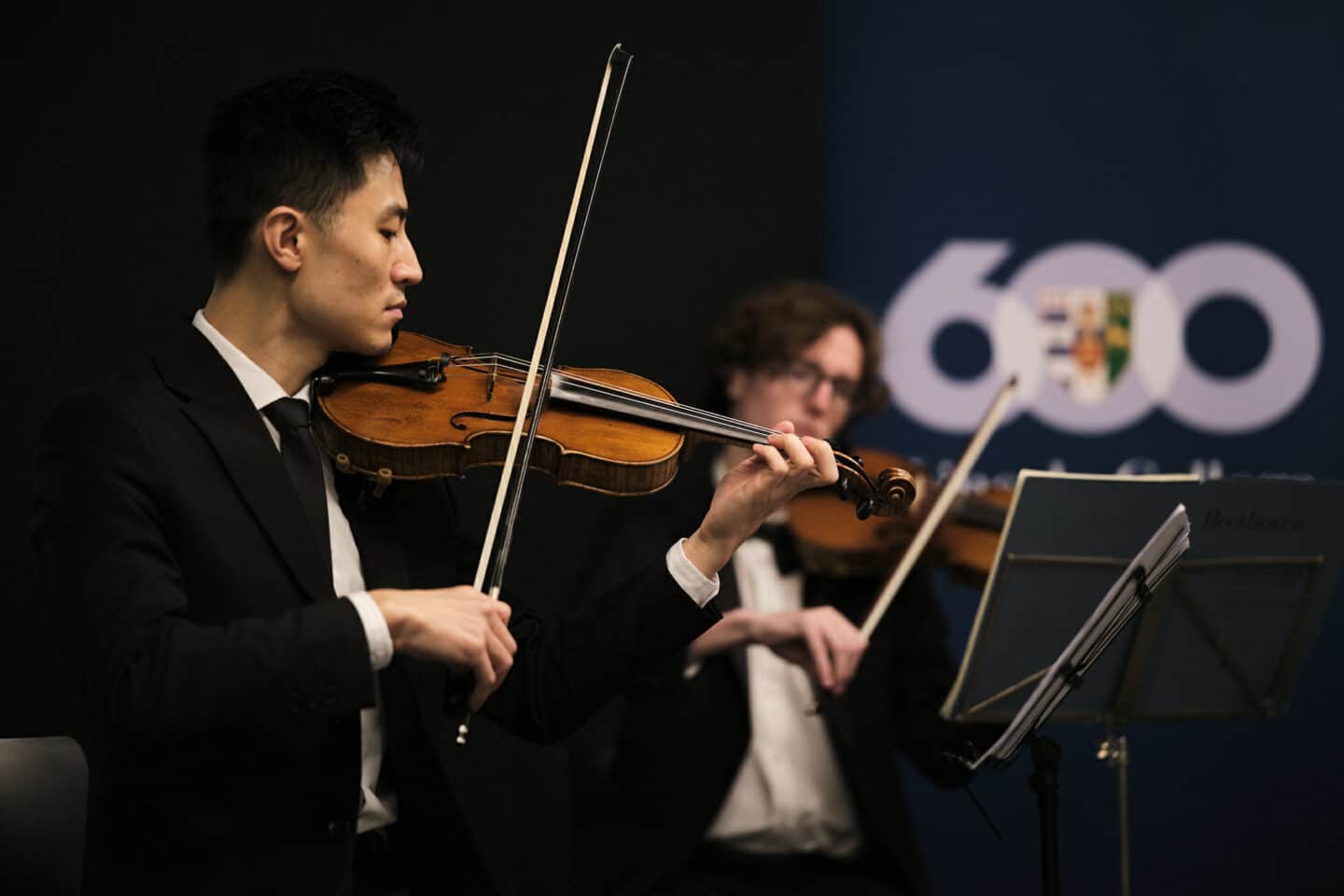 violin players at the 600 campaign launch