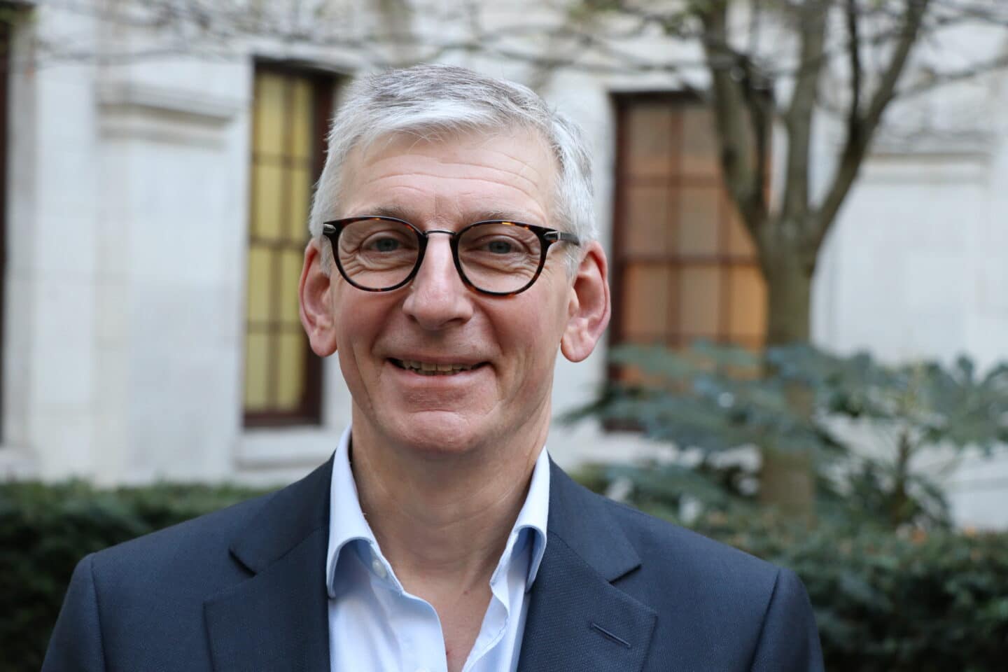 Photo of Nigel Clifford wearing a blue shirt and jacket