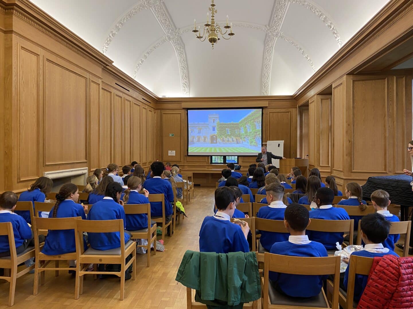 A group of primary school students watching a presentation in the Oakeshott Room