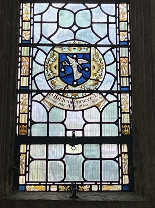 Stained glass window bearing an image of an angel and the name of G. Baldwin Spencer