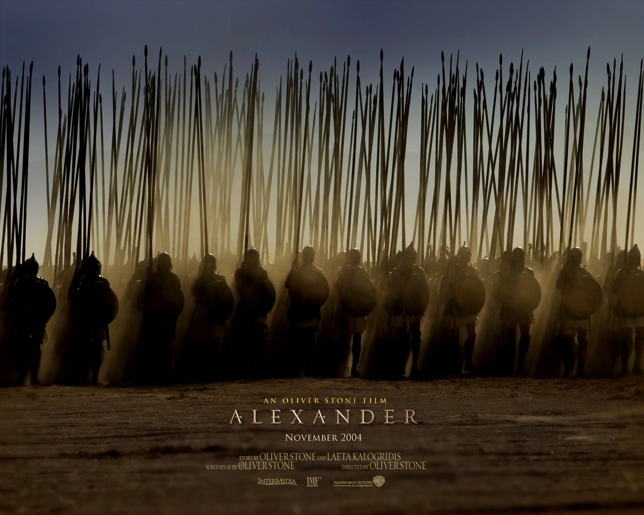 Poster from the film 'Alexander' (2004) showing a line of Macedonian soldiers in formation with long spears raised, silhouetted dramatically against a dusty battlefield under a dusky sky. The title and credits appear at the bottom.