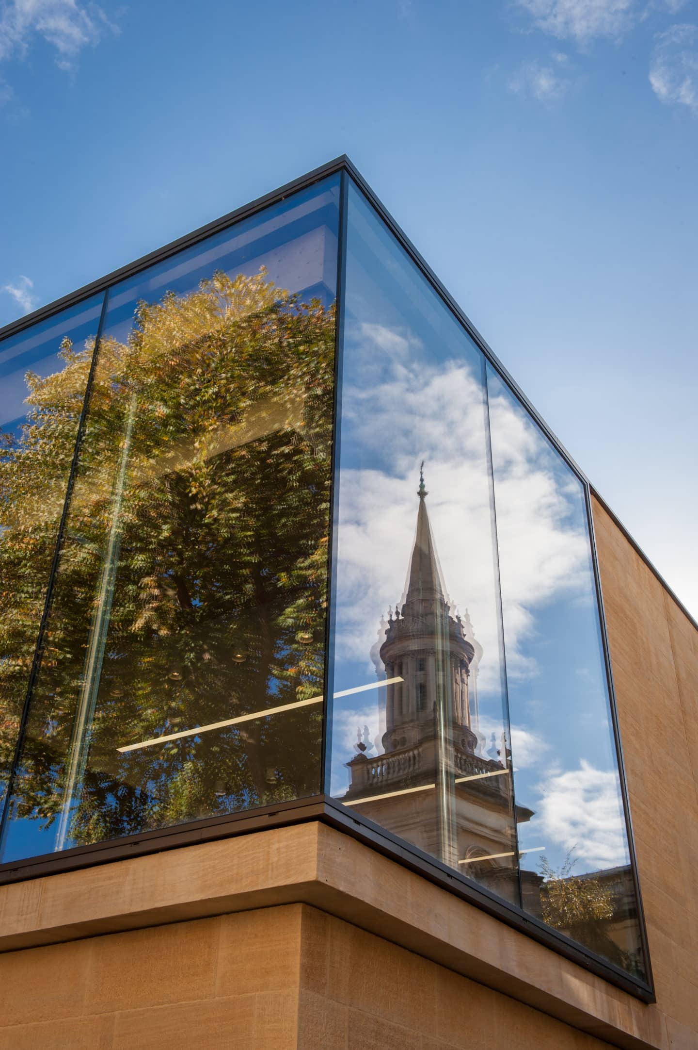 The Library tower reflected in the glass of the Berrow Foundation Building