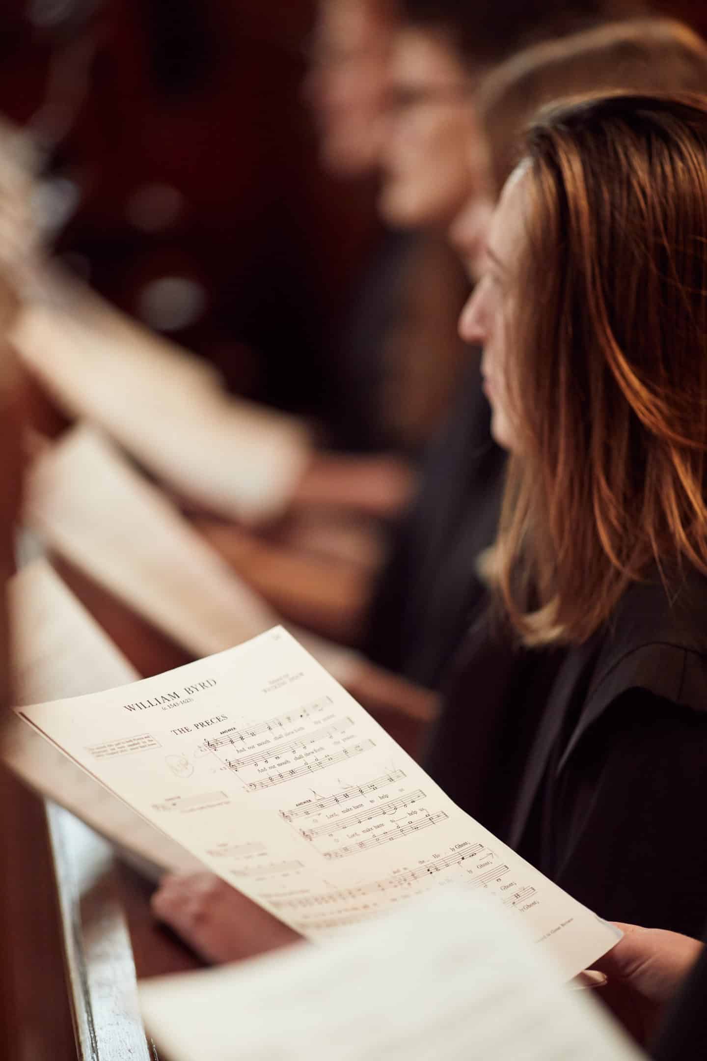 Choir member with music sheet in the Chapel