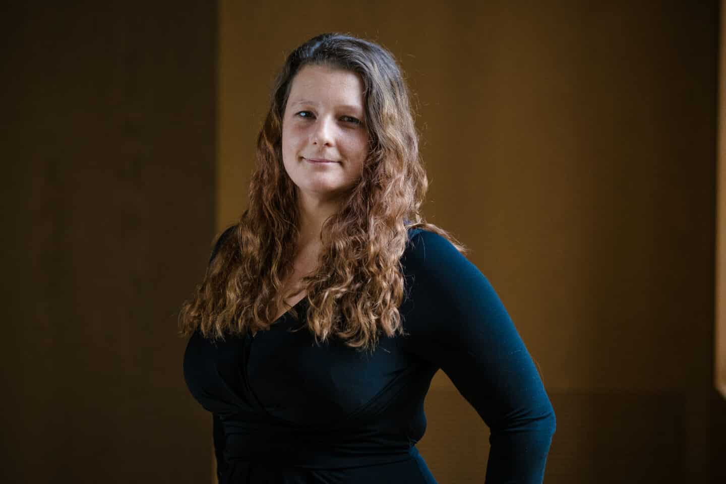Headshot of Claire Riseley, a woman in a blue top