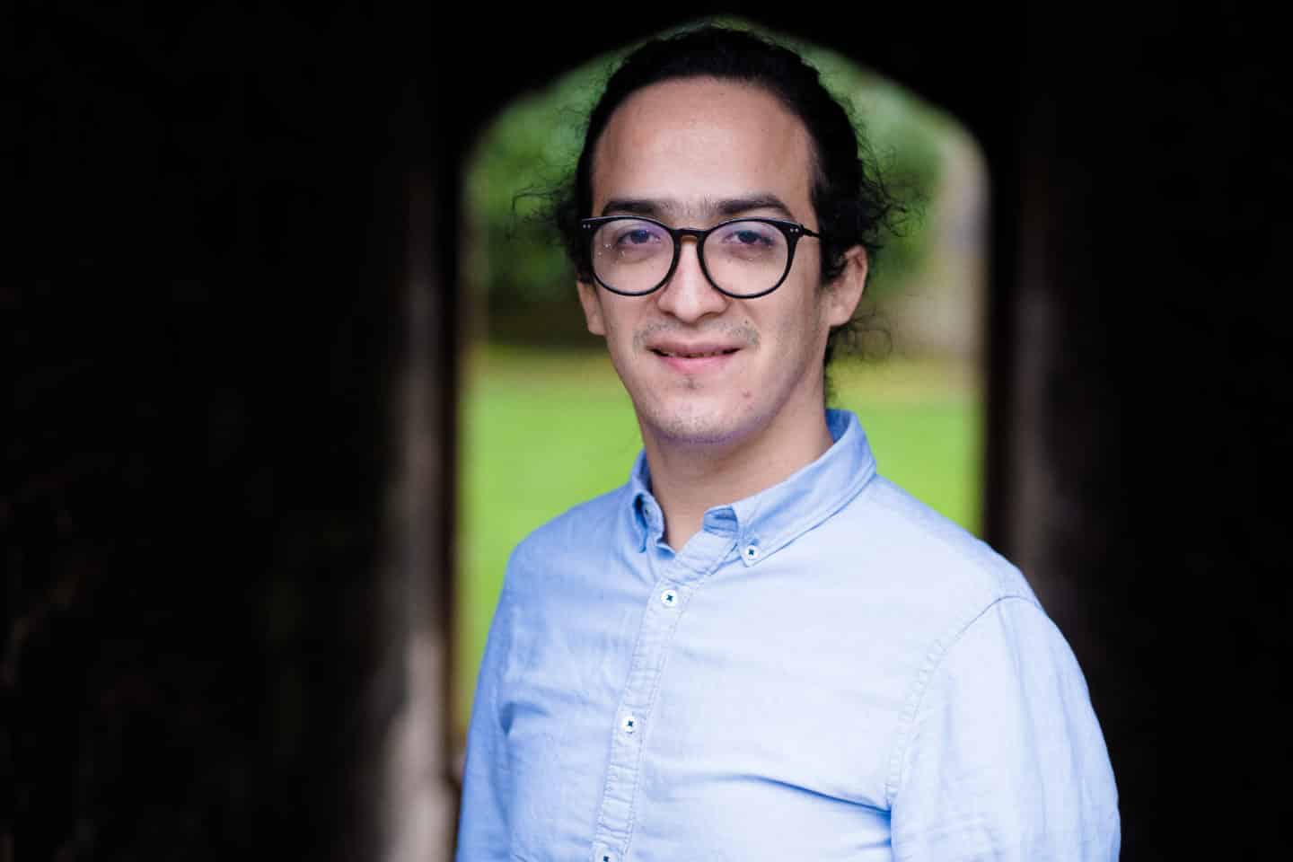 Headshot of Diego Aguilar Ramirez, a man in glasses and a light blue shirt