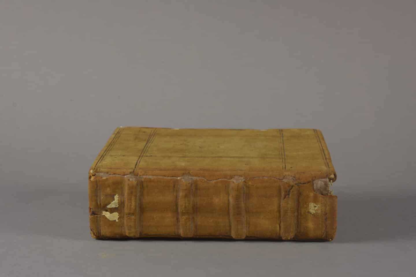 A 12th century manuscript, closed to display its slightly damaged but restored leather spine
