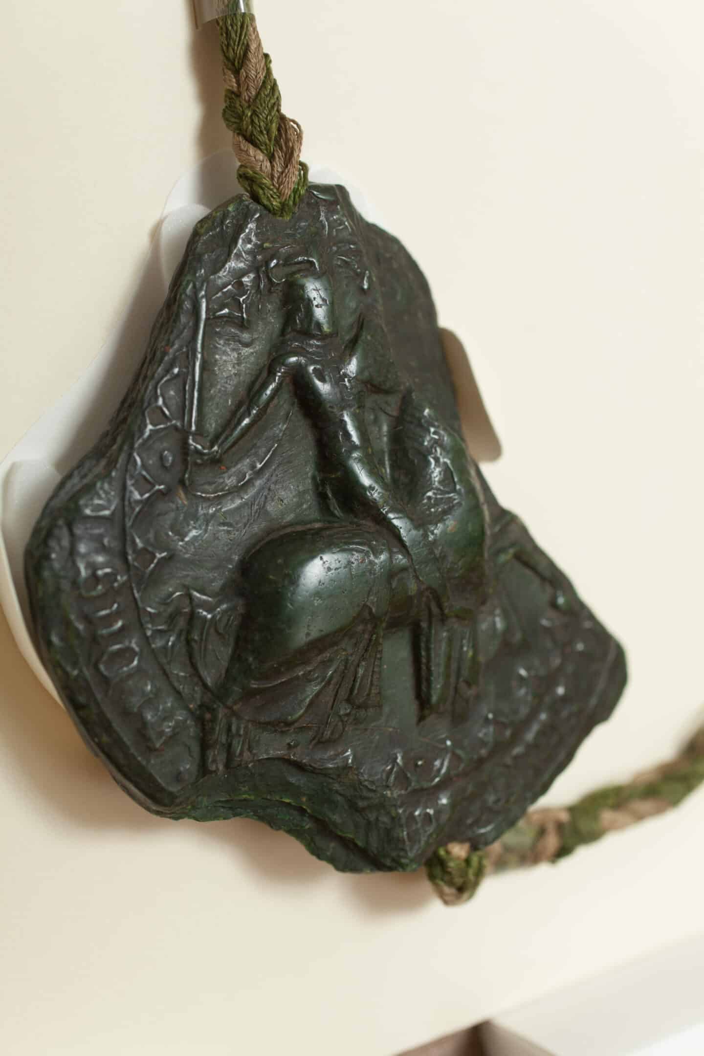 Slightly melted wax seal featuring a man on a horse