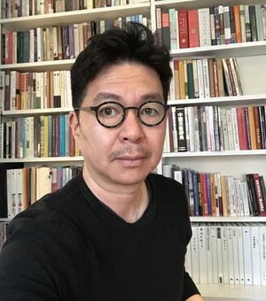 Photograph of Professor J. P. Park in front of a bookcase