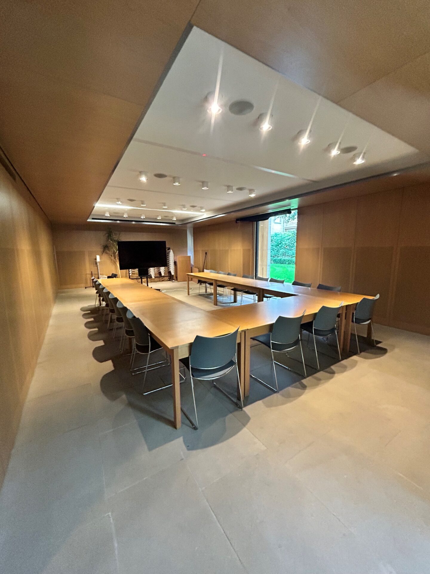 Photograph of the Lower Lecture Room, with chairs arranged in a U-shape, facing a screen at the front