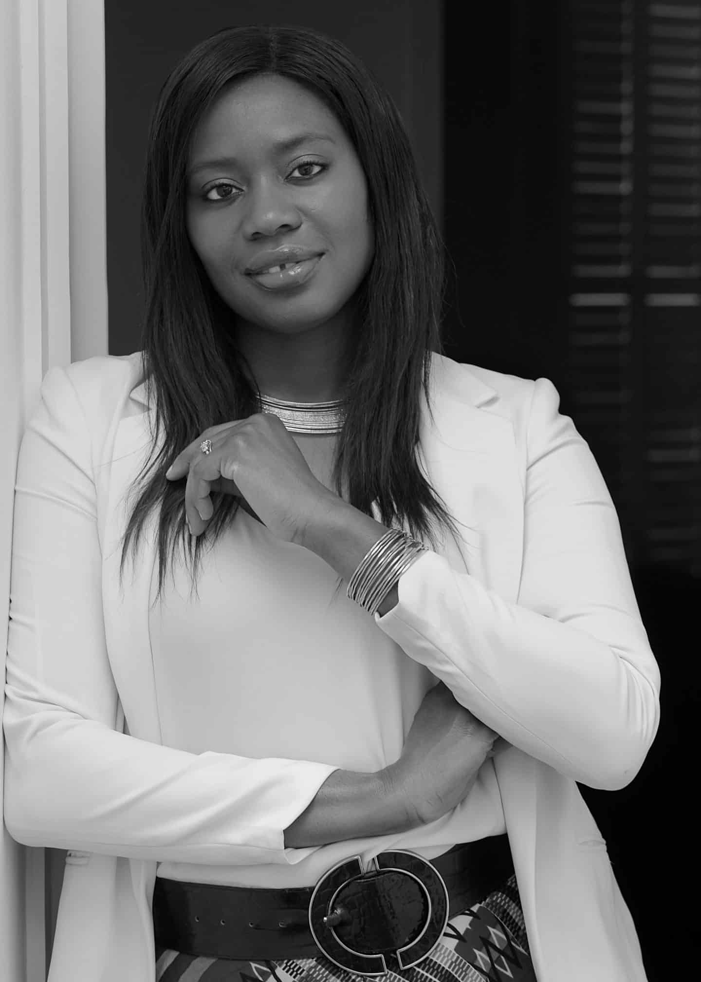 Greyscale photograph of Miatta Fahnbulleh, a woman wearing a necklace and bracelet