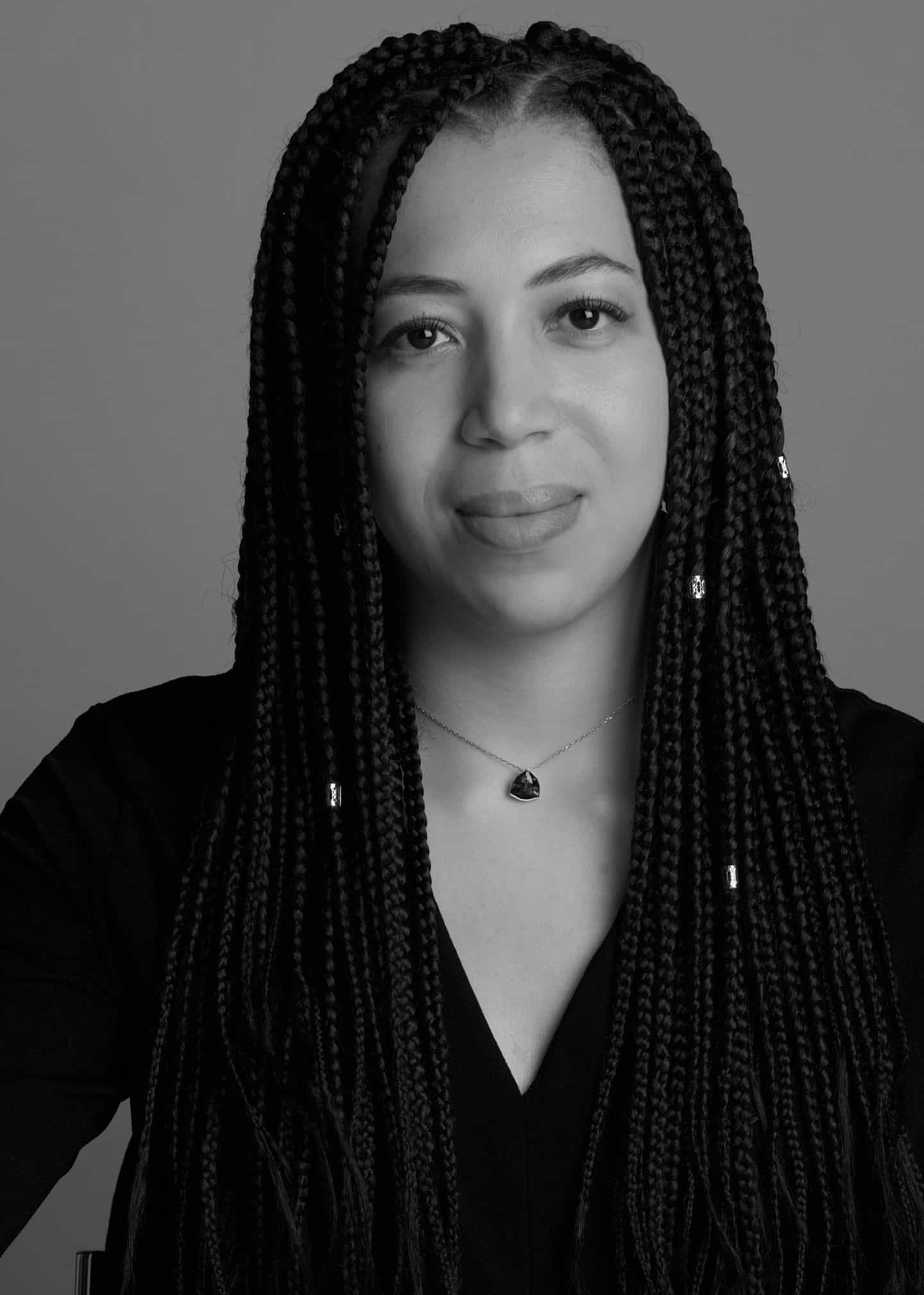 Greyscale photograph of Naomi Kellman, a woman in a black top and necklace