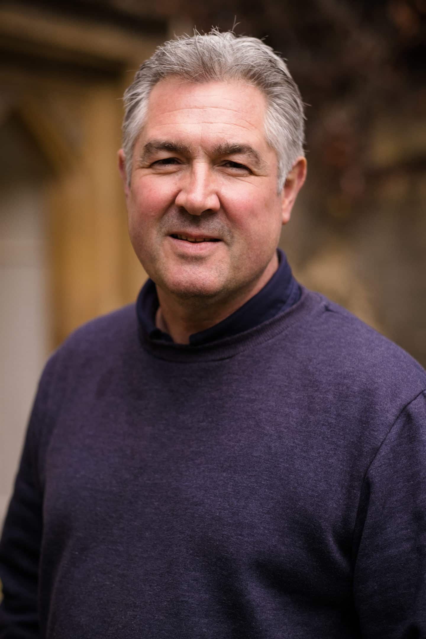 Headshot of Robert Williams, a man in a purple sweatshirt