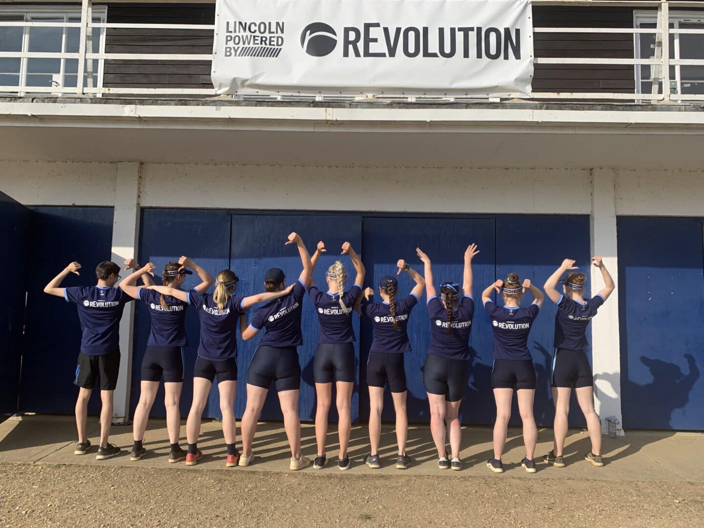 W1 representing our sponsor, rEvolution - the crew is standing with their backs to the camera, showing off their blue t-shirts with the Revolution logo