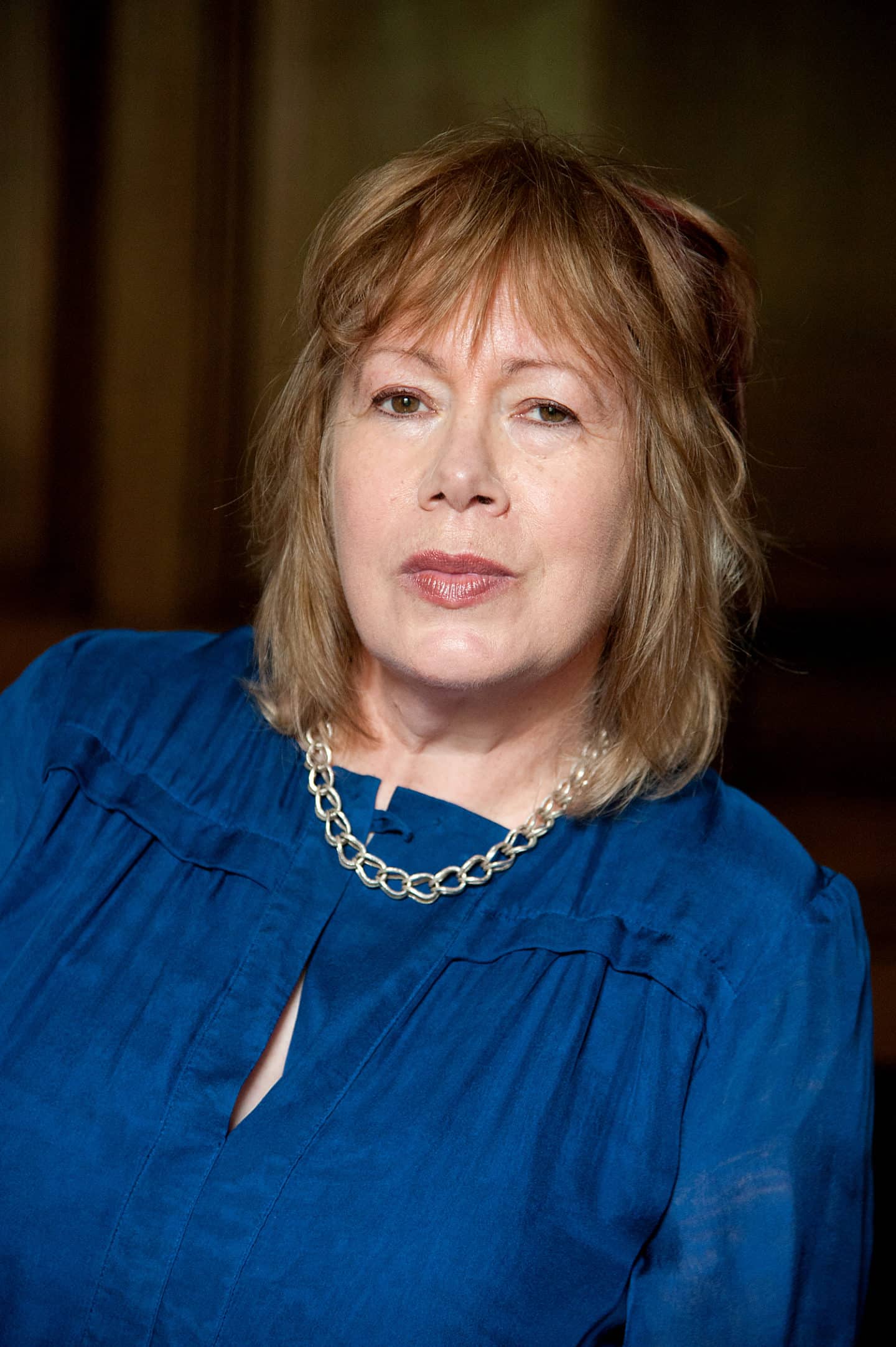 Headshot of Susan Brigden, a woman in a blue top and a necklace
