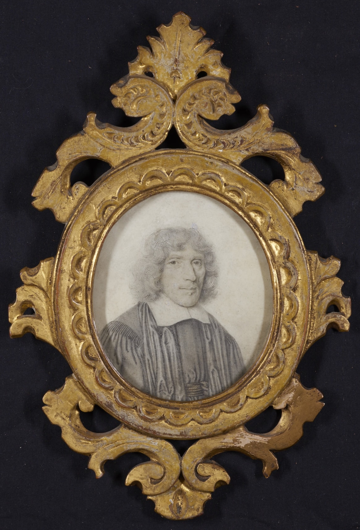 Black and white drawing of a man, nestled within an ornate golden frame